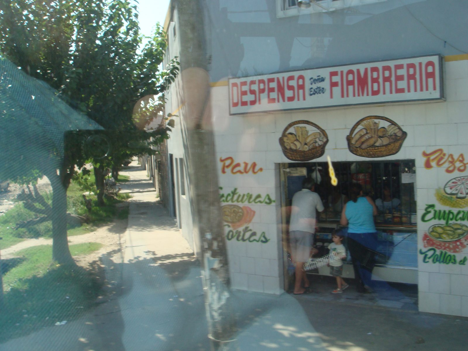 A corner grocery seen from the bus