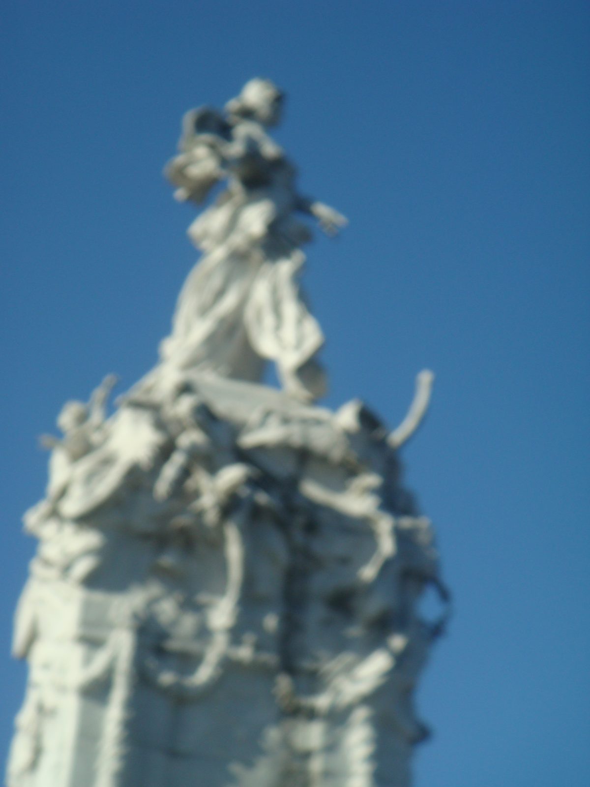 The ornate statue group at the top of the column