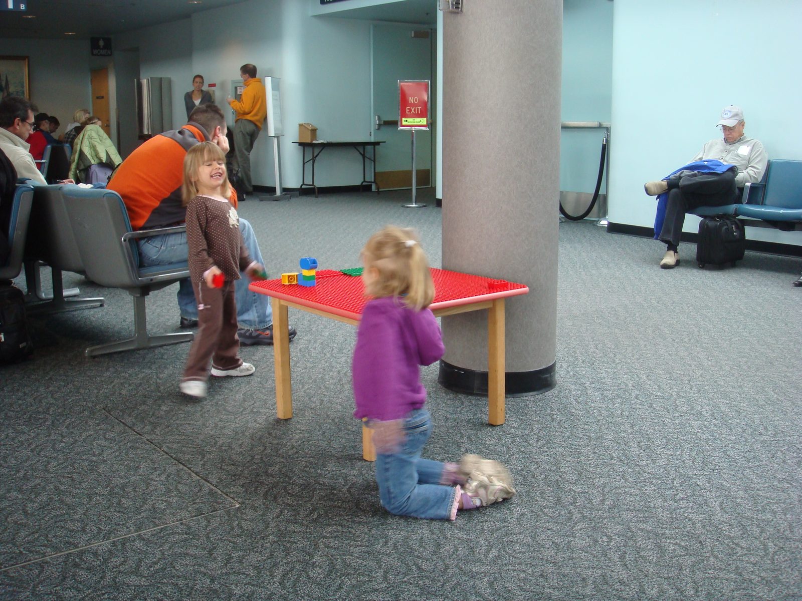 Lisa playing at the airport gate