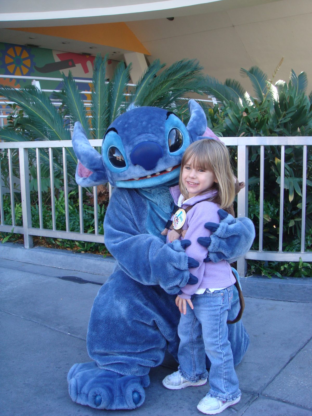 Lisa in a big hug from Stitch at Magic Kingdom