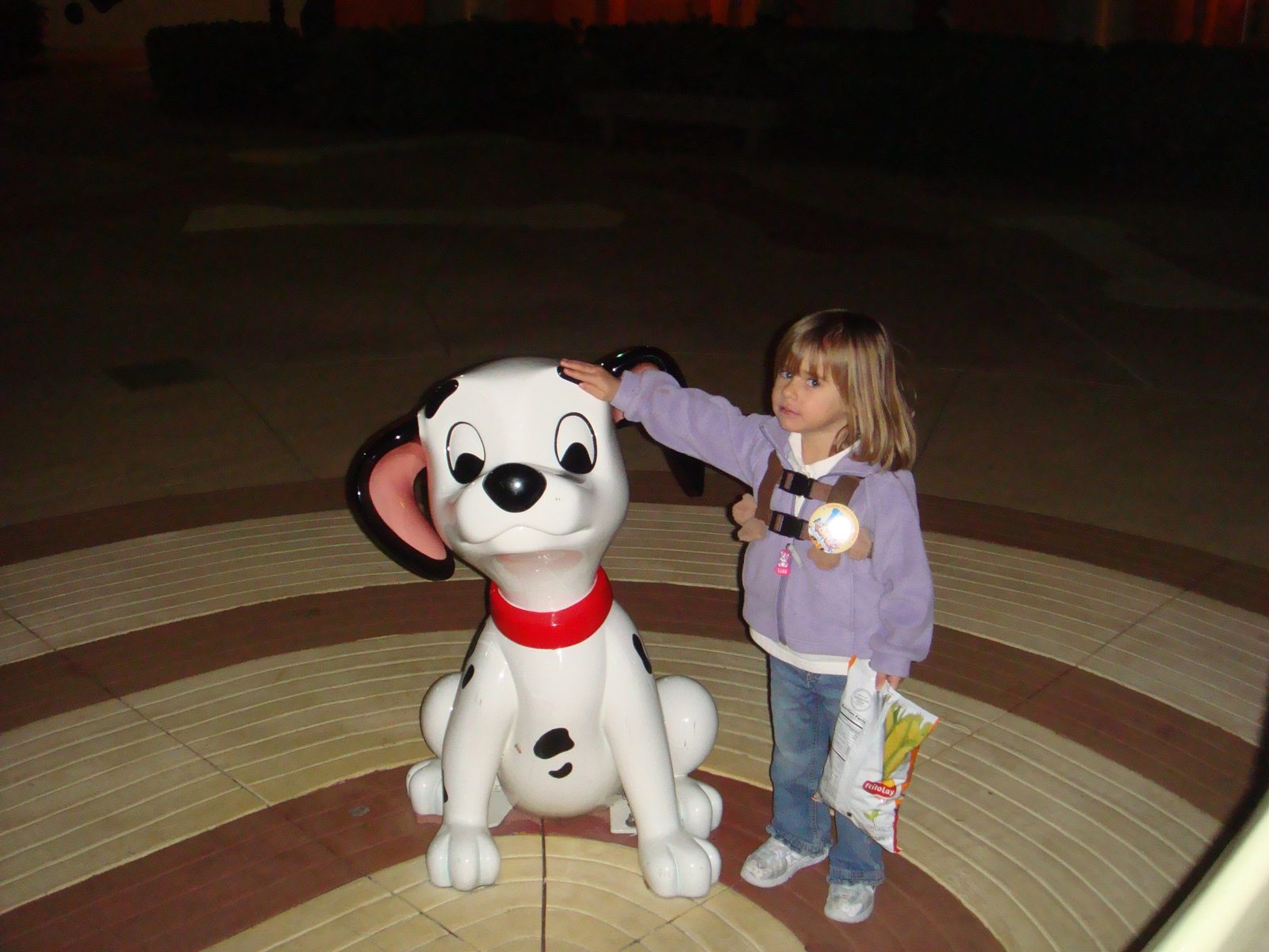 Lisa says hello to the Dalmatian statue at night