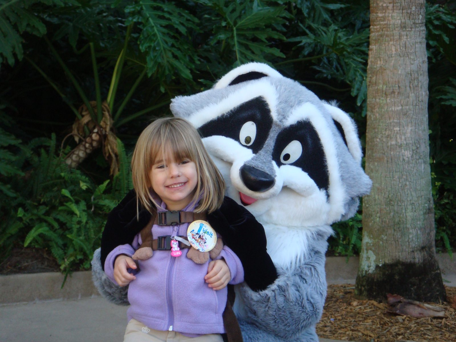 Lisa meets a raccoon character at Animal Kingdom