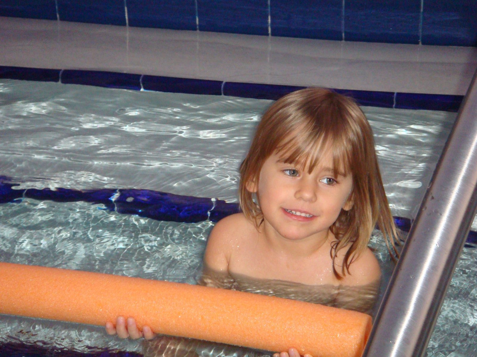 Lisa swimming with her pool noodle