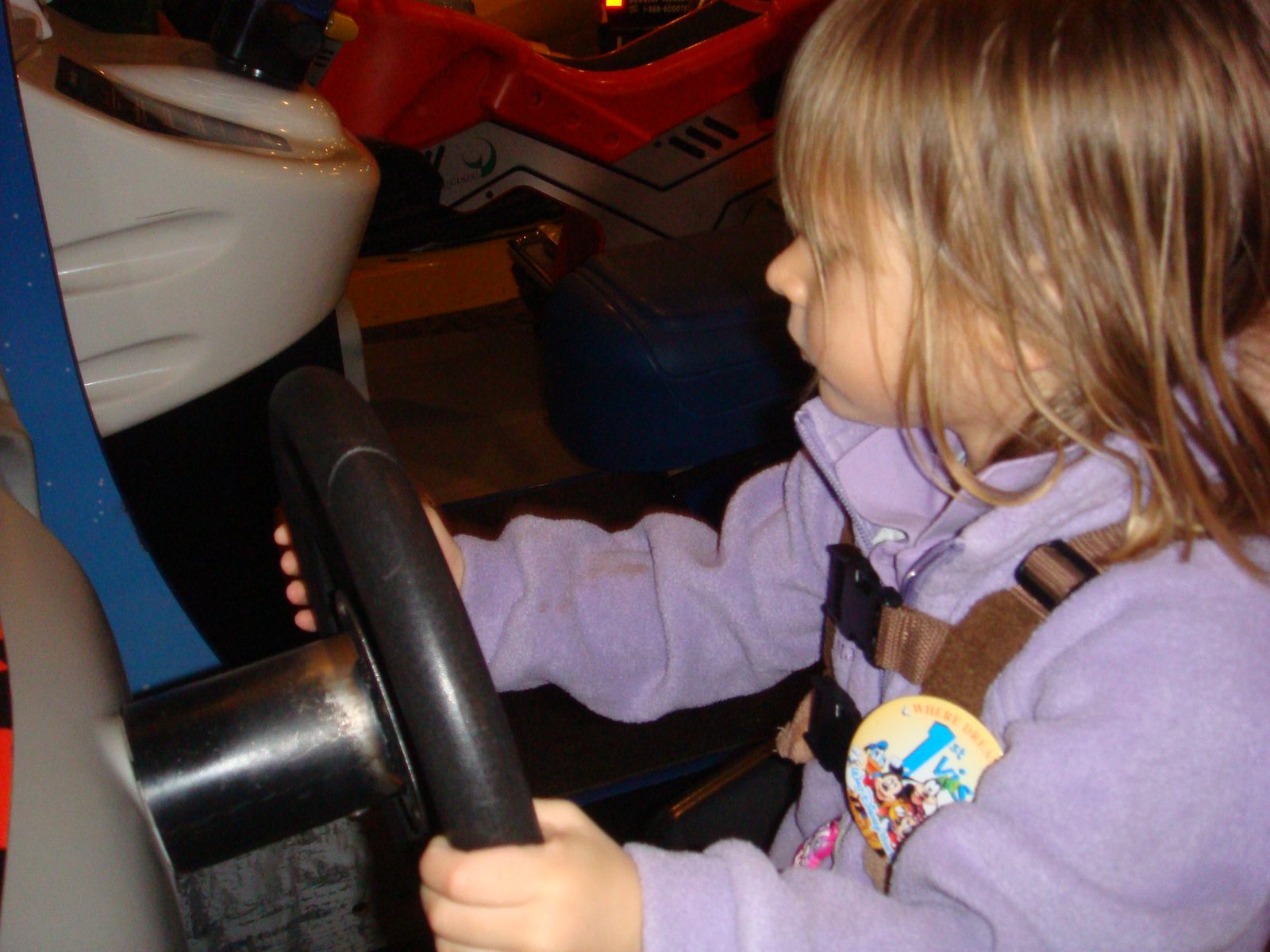 Lisa behind the wheel at the arcade