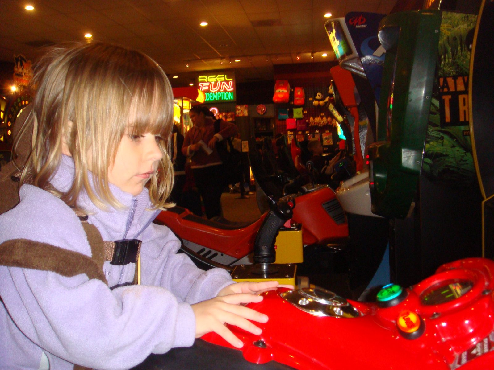 Lisa playing a driving game in the arcade