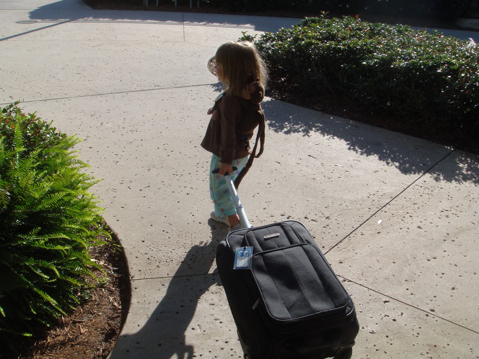 Lisa rolling her own suitcase out of the resort