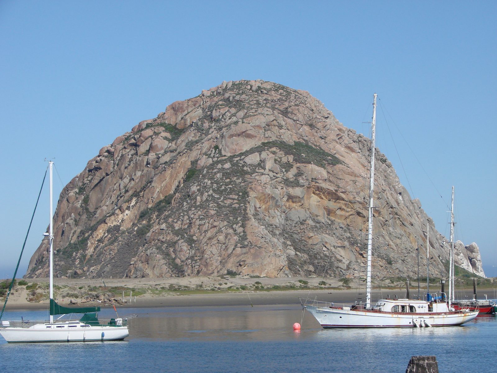 Sailboats anchored below Morro Rock