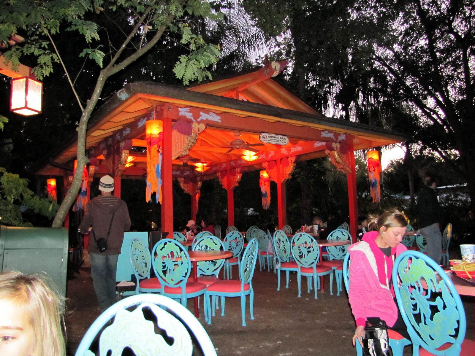 Lanterns glowing over an outdoor dining pavilion
