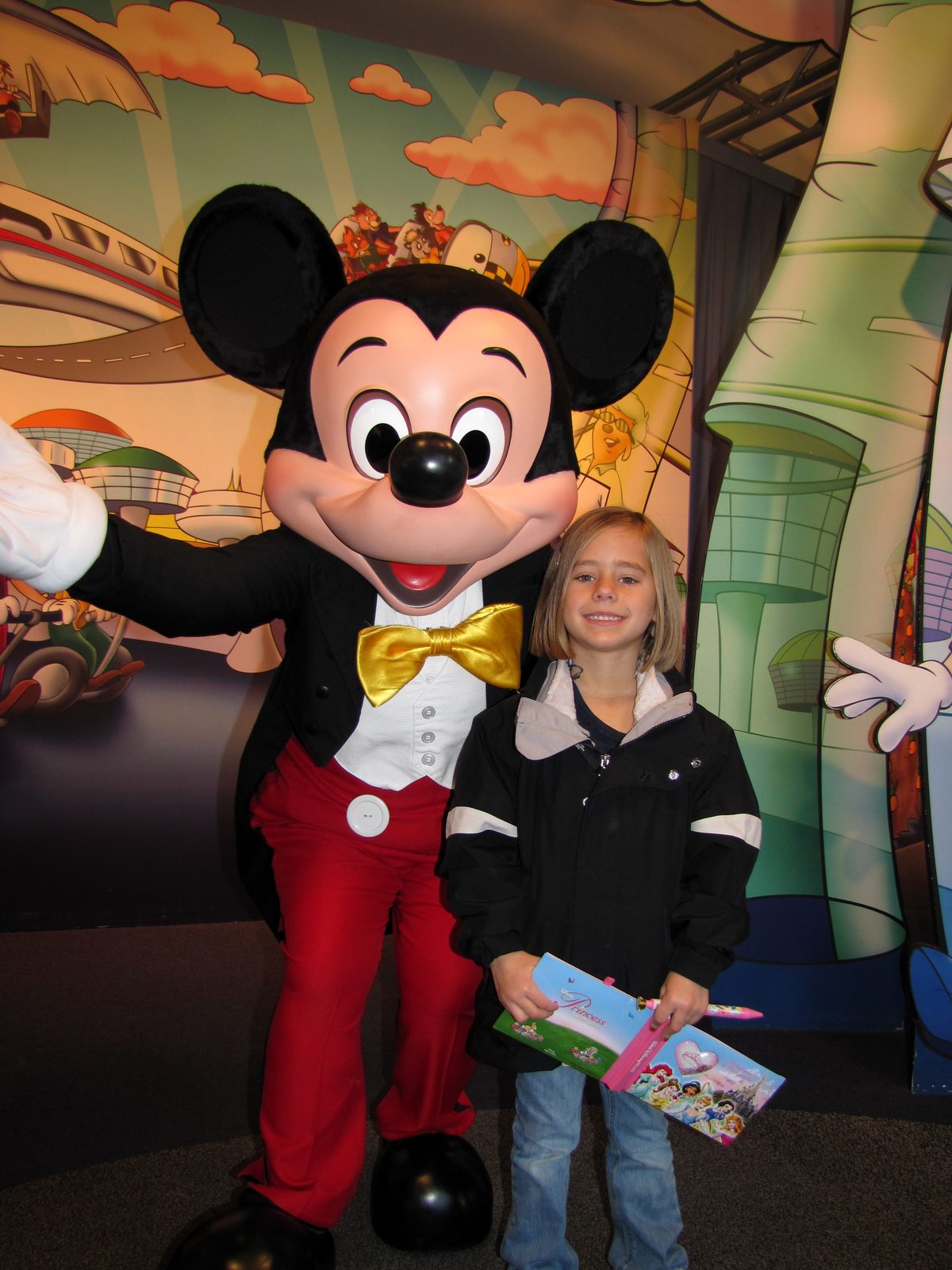 Mickey Mouse in his tuxedo and Lisa at Epcot