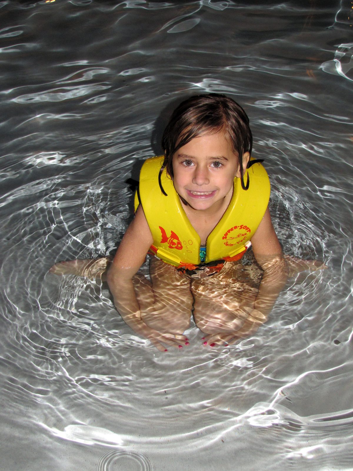 Lisa in her life jacket in the zero entry pool