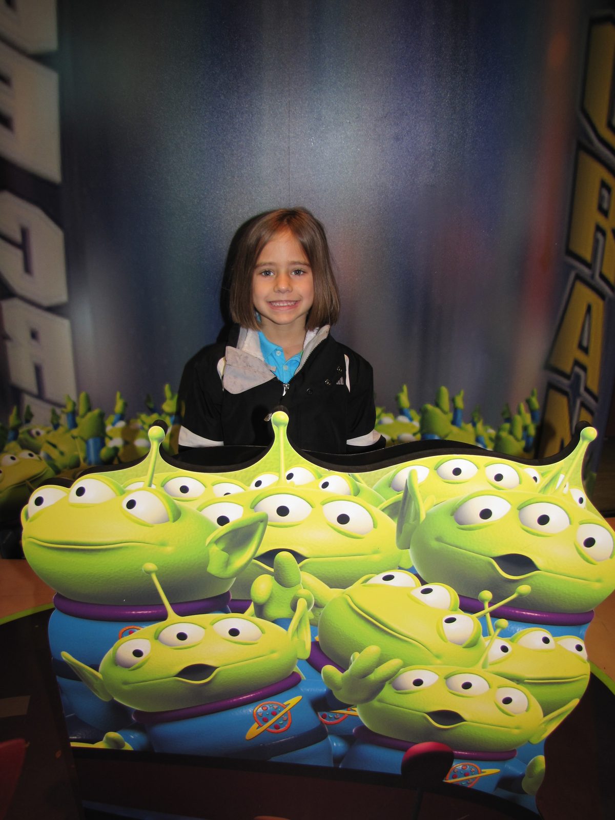 Lisa behind the Toy Story aliens, still waiting in line