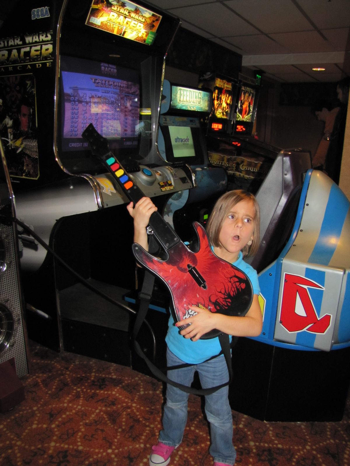 Lisa playing Guitar Hero in the lodge arcade