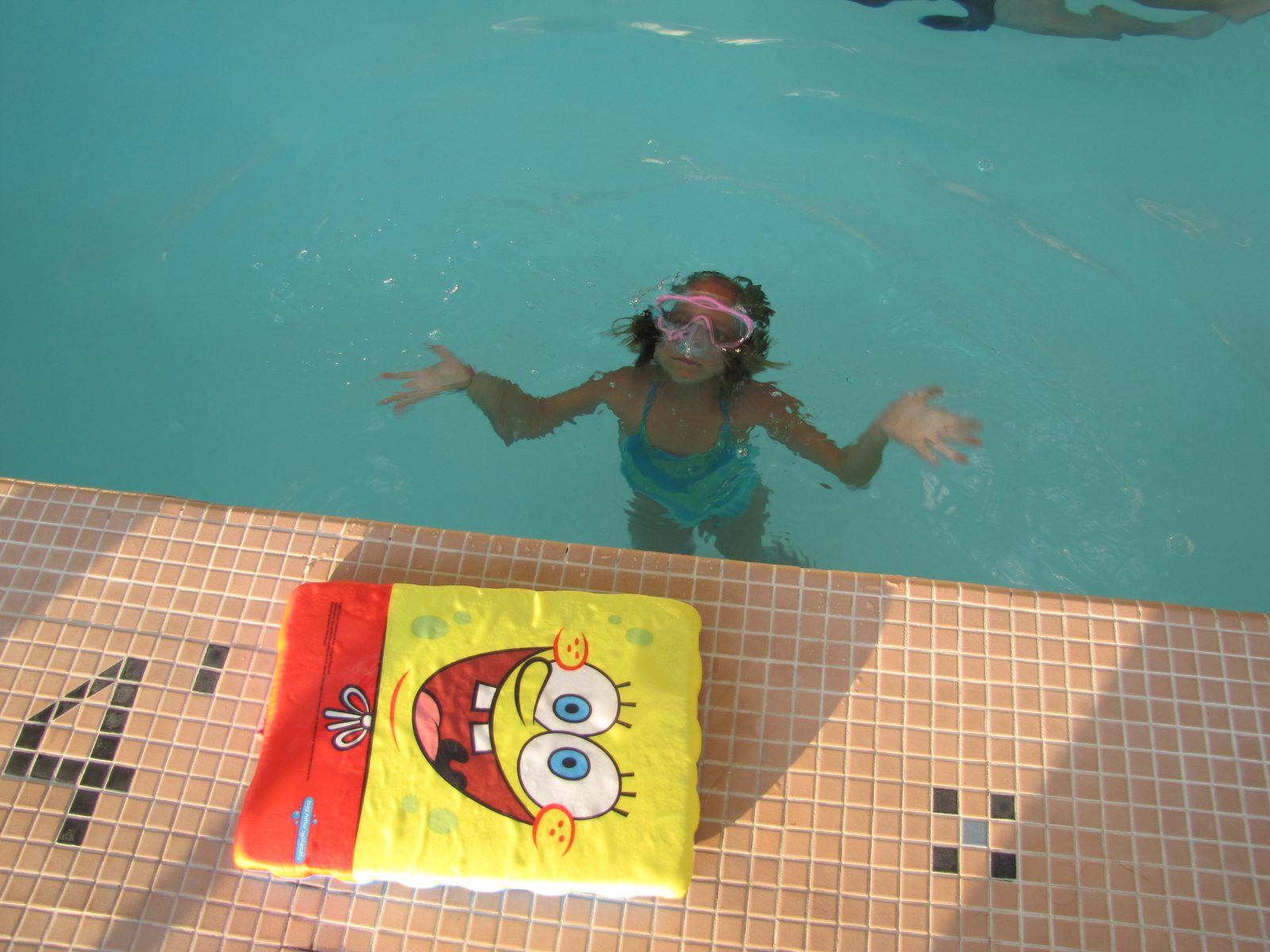 Lisa in the pool with her goggles on
