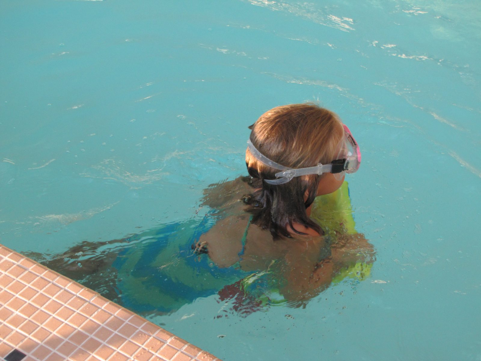 Lisa swimming with her SpongeBob kickboard