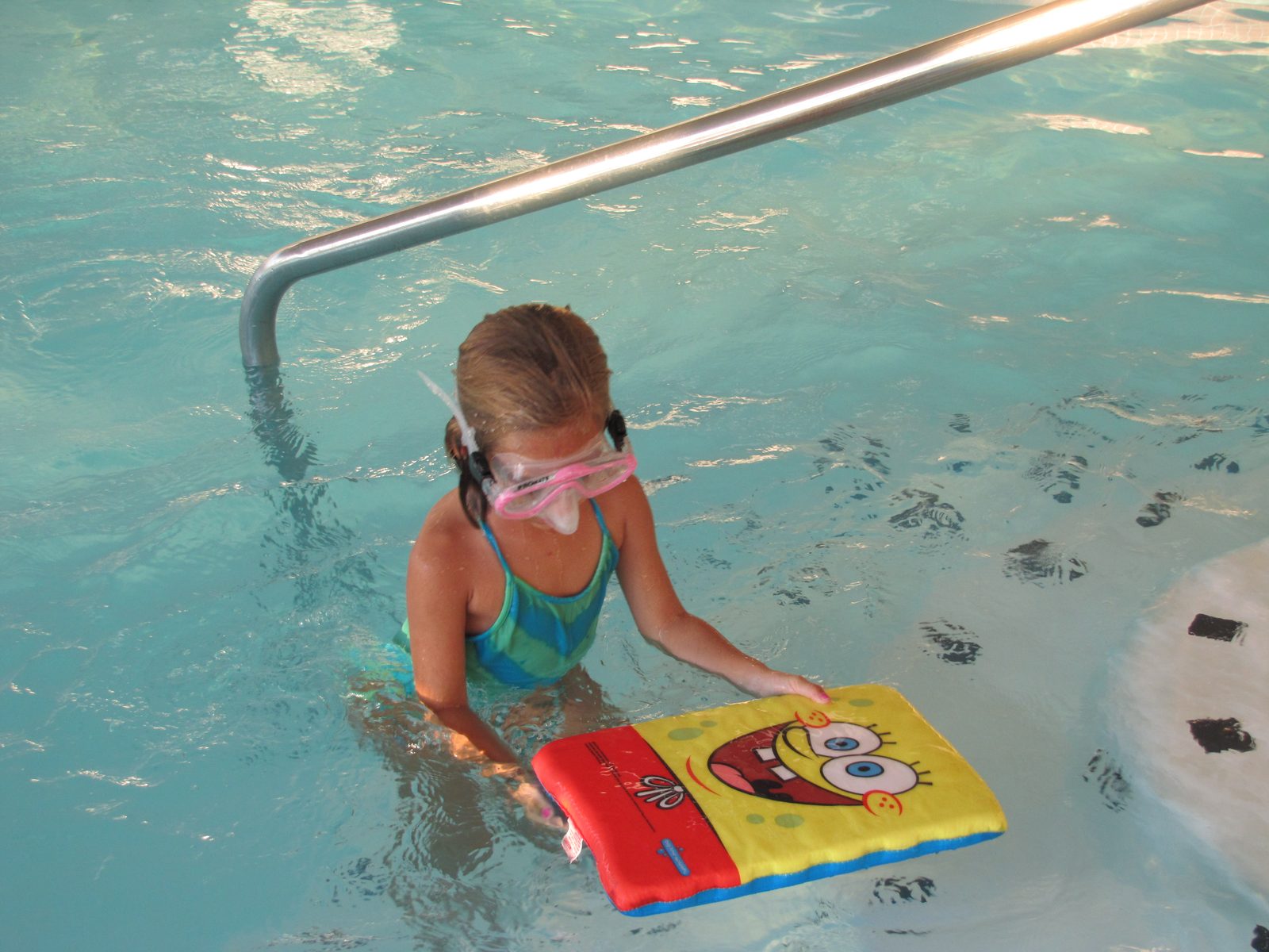 Lisa swims with her SpongeBob kickboard