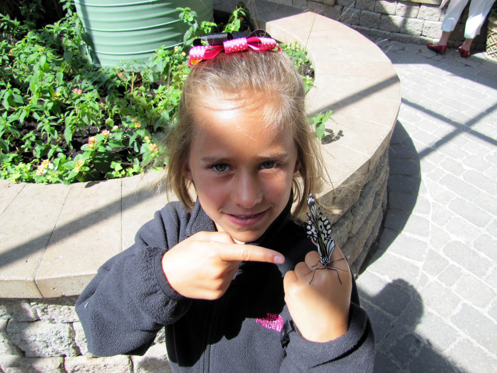 Lisa pointing out the butterfly on her finger