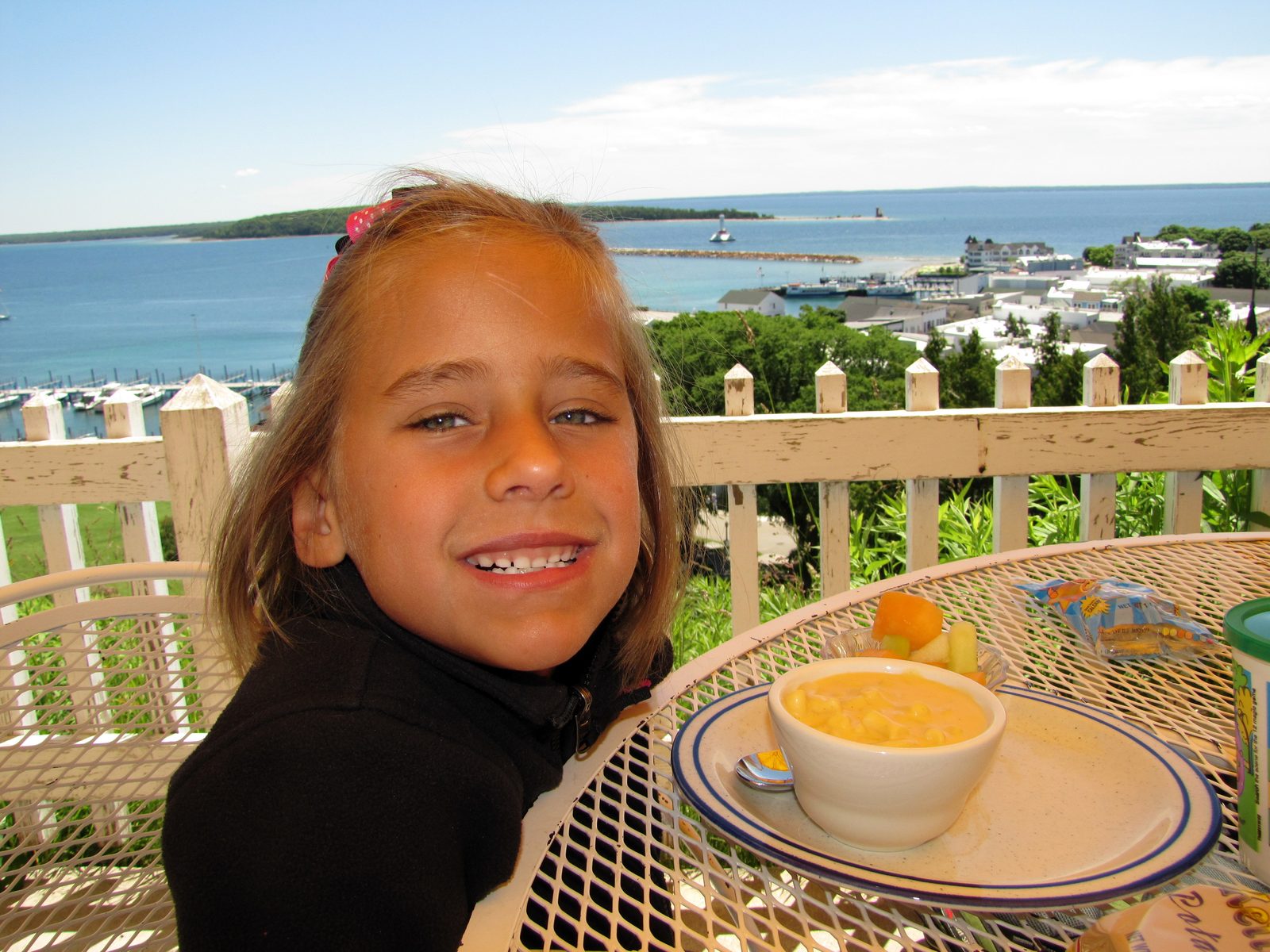 Lisa at the Tea Room with the harbor behind her