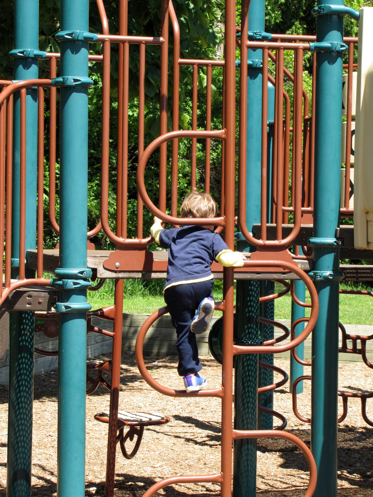 Thomas climbing the playground at Marquette Park