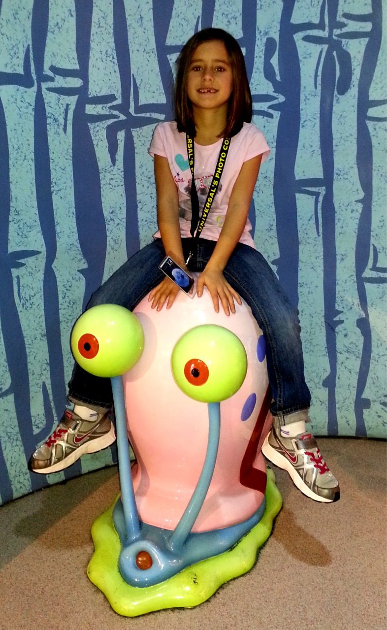 Lisa riding the Gary statue at Universal Studios