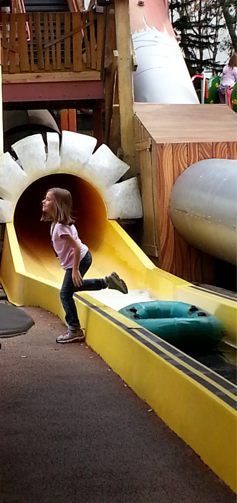 Lisa hopping off the end of the tube slide