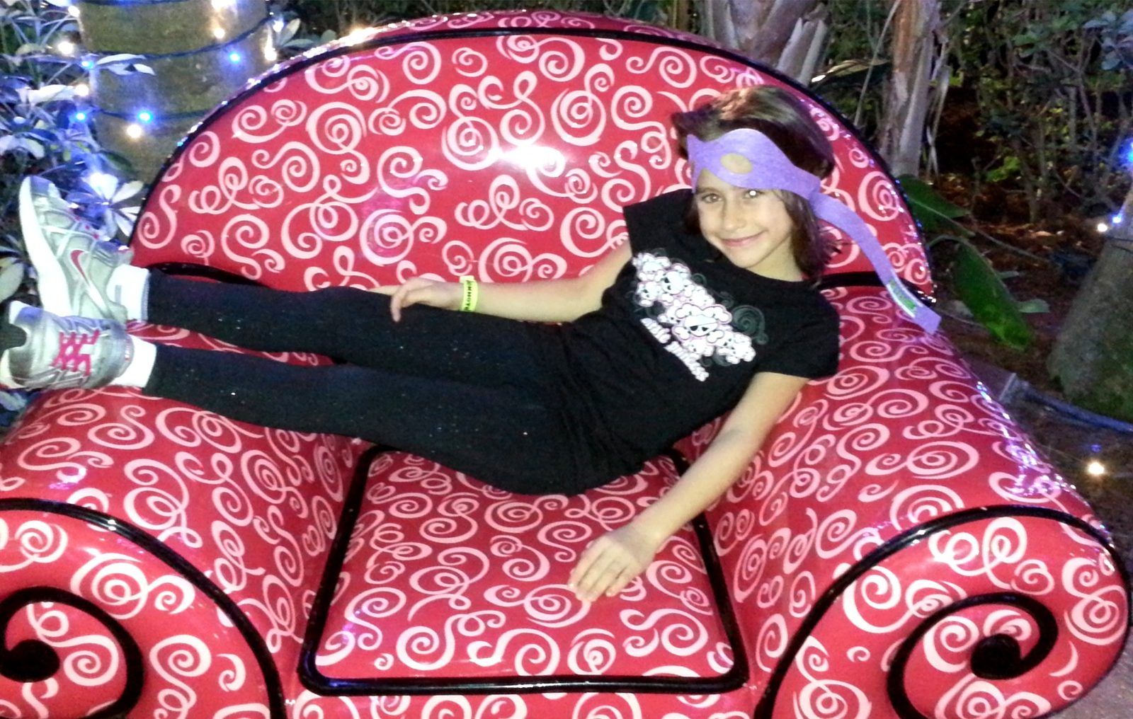 Lisa on the big swirly chair in the resort courtyard