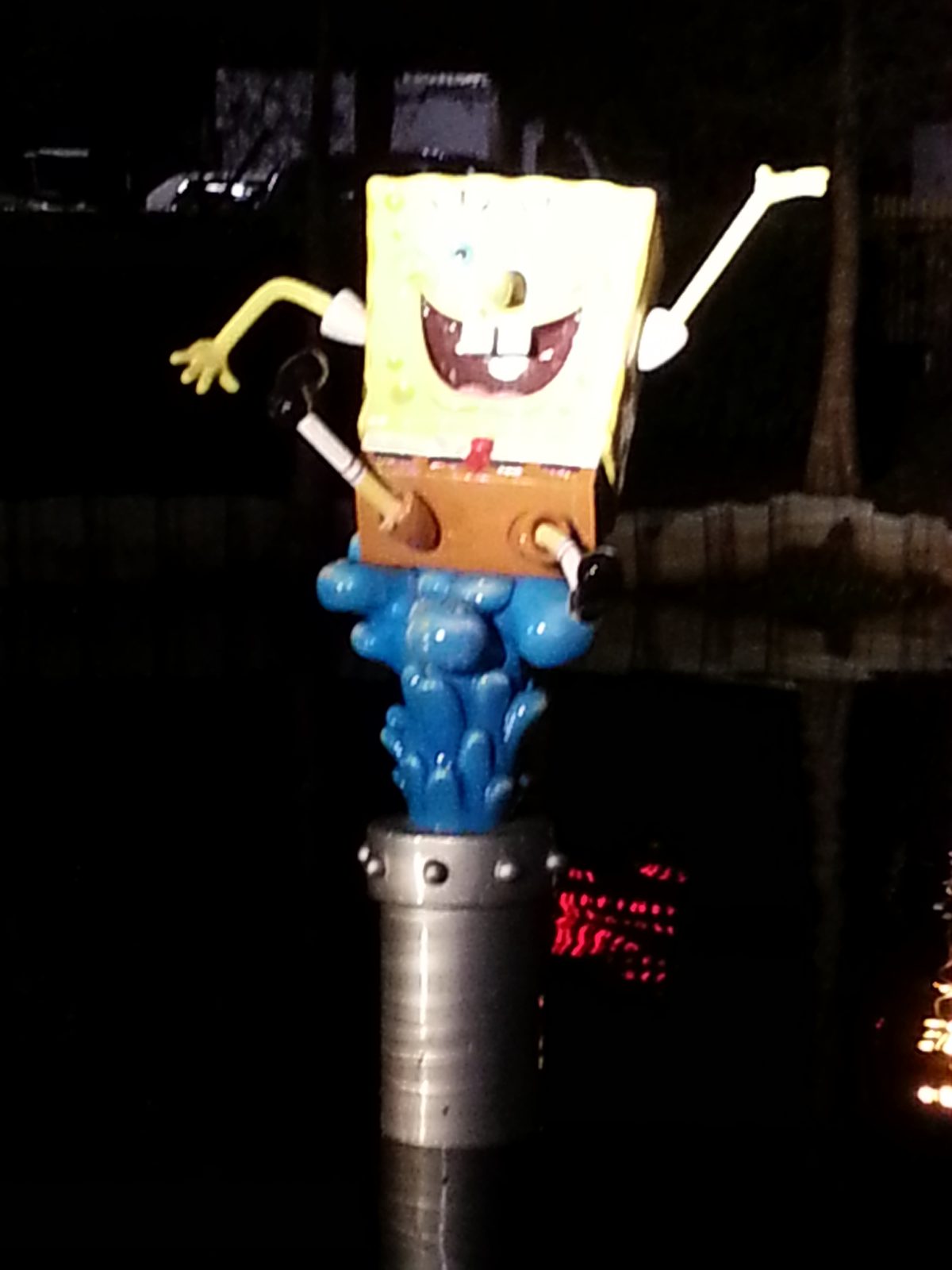 The SpongeBob statue lit up at night