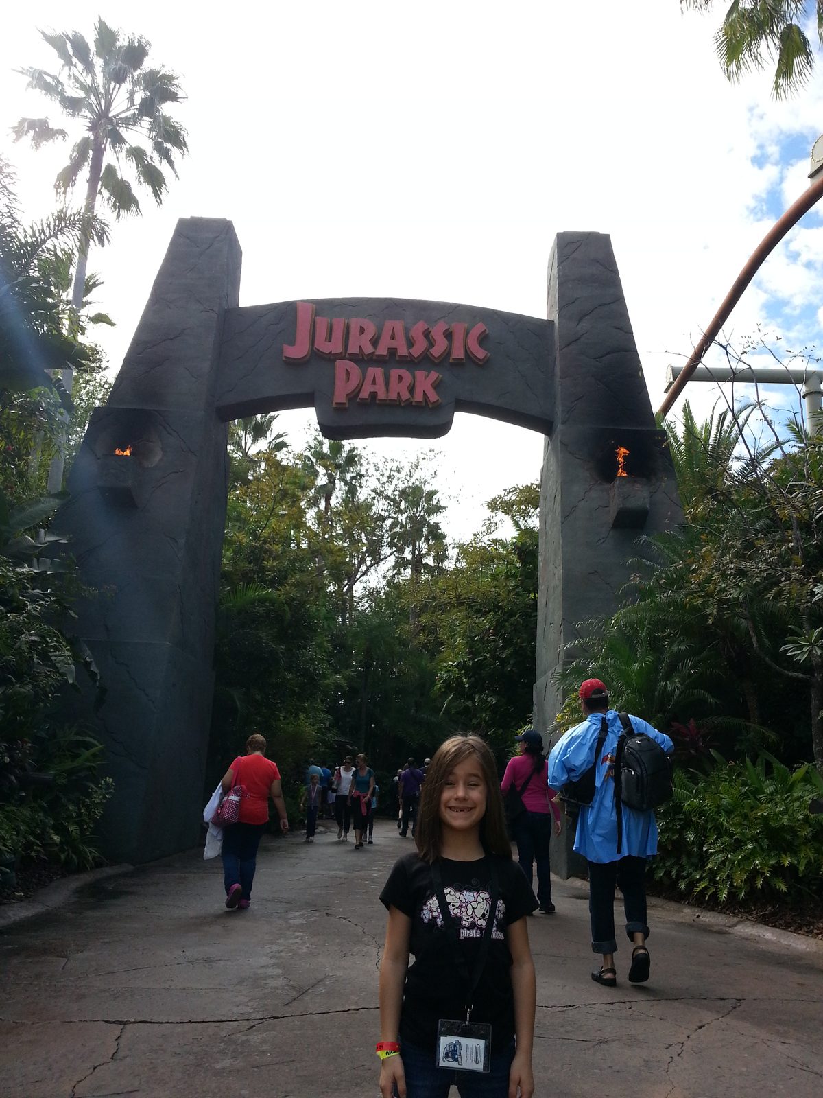 Lisa walking under the Jurassic Park arch