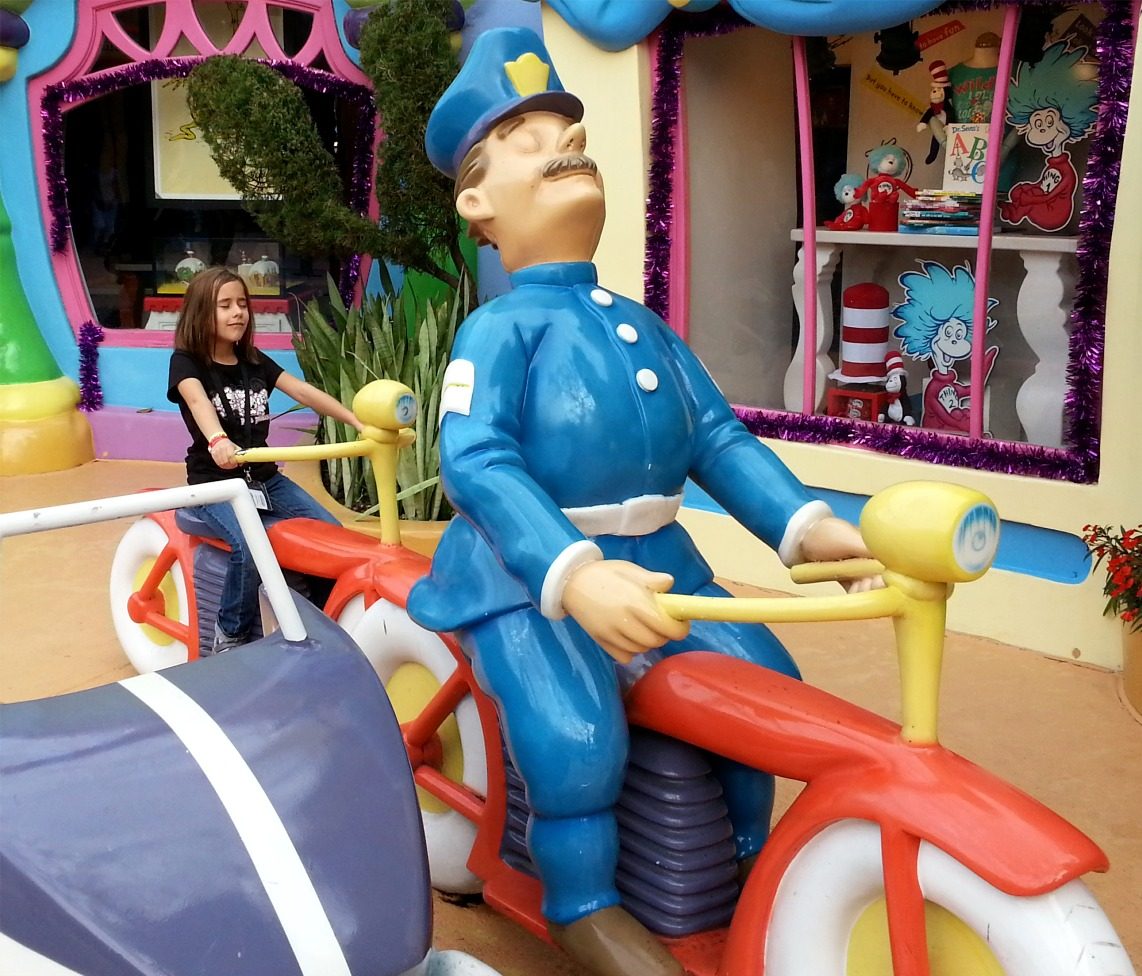 Lisa with the police officer statue in Seuss Landing