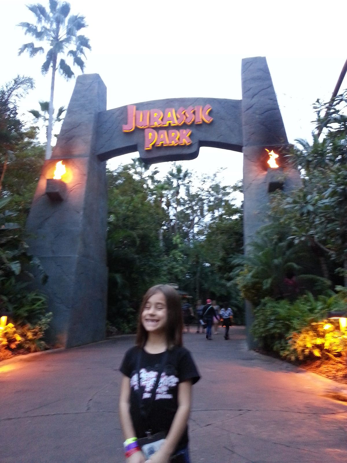 The Jurassic Park arch lit up at dusk