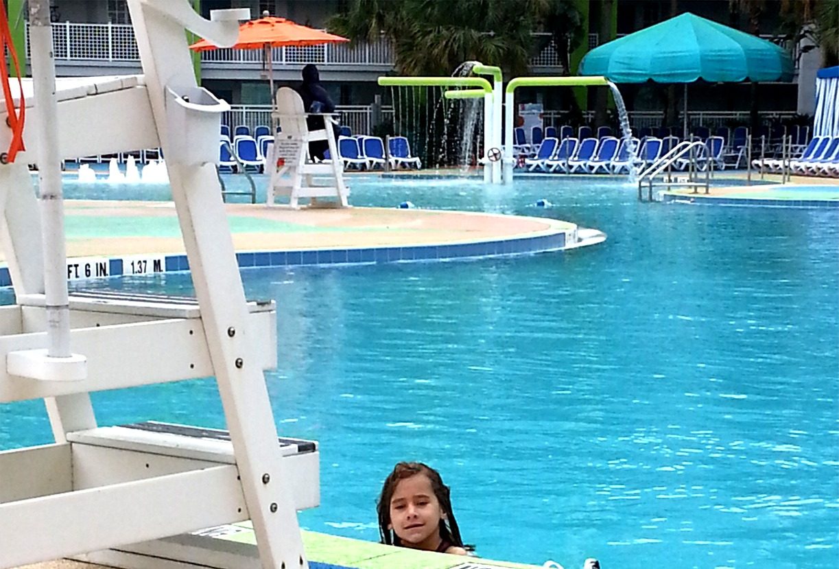 Lisa in the resort pool by the lifeguard stand