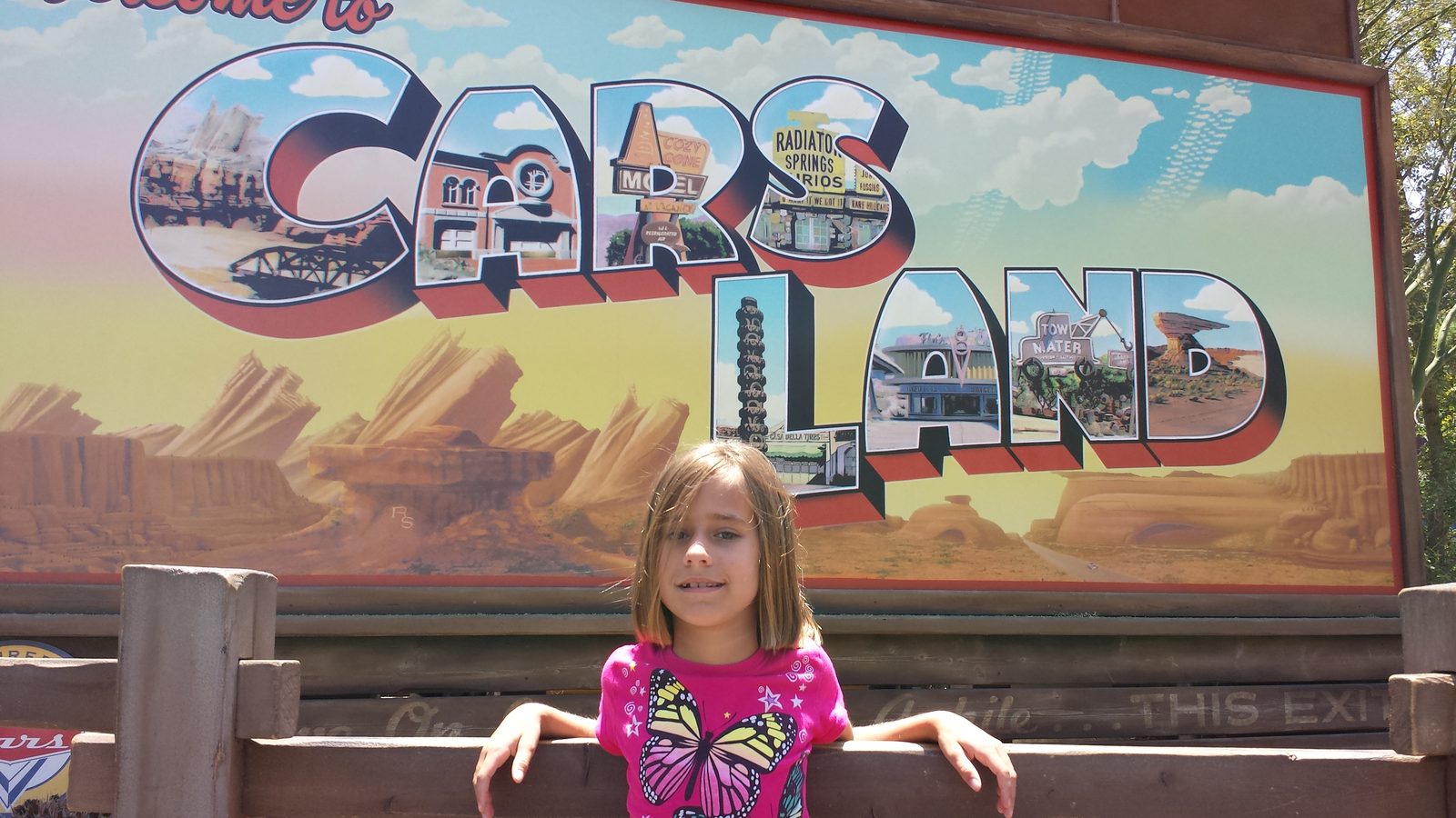 Lisa at the Cars Land sign