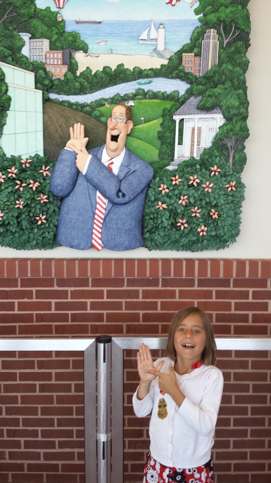 Lisa claps along with a mural on the drive to the airport