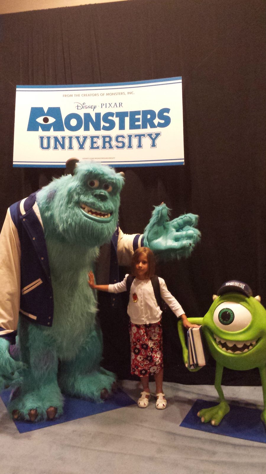 Lisa poses under the Monsters University sign