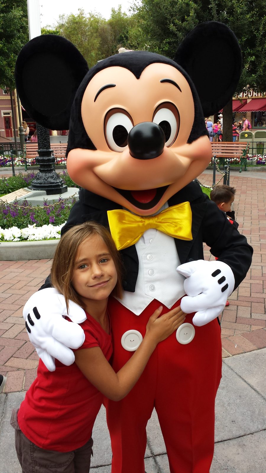 Lisa hugs Mickey Mouse