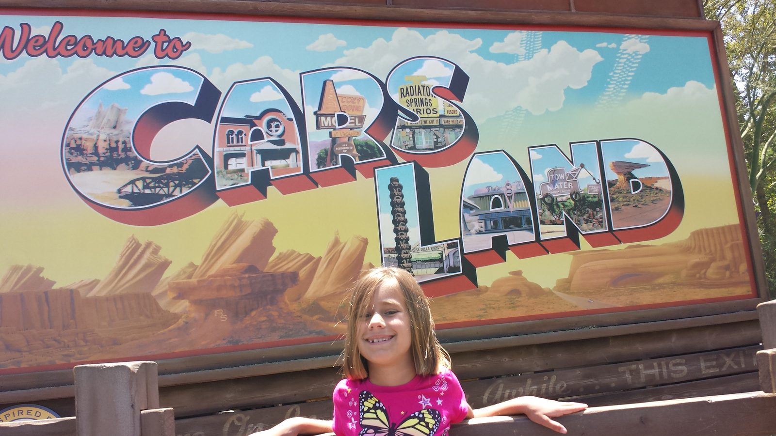 Lisa at the Welcome to Cars Land sign