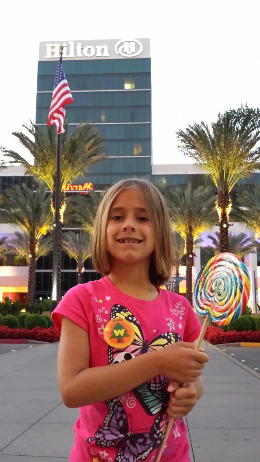 Lisa outside the Hilton at dusk