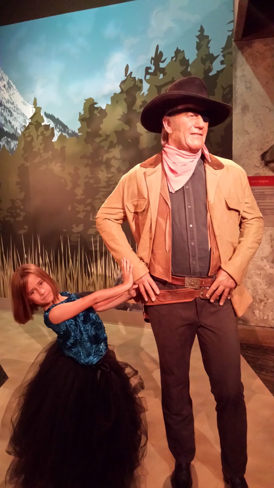 Lisa with a cowboy wax figure at Madame Tussauds