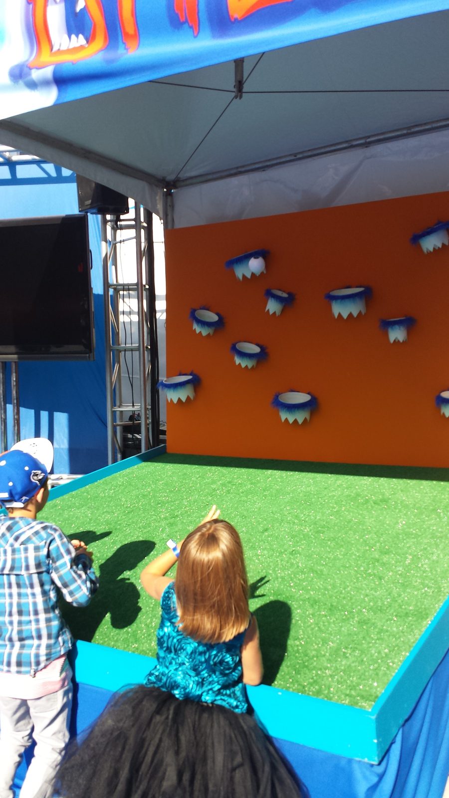 Lisa playing a carnival game at the tailgate party
