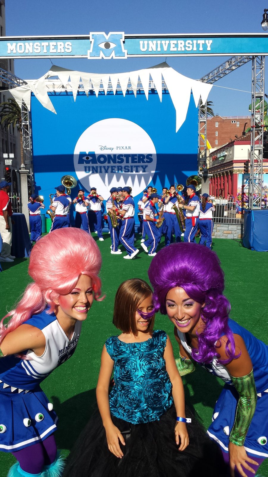 Lisa between costumed fans at the tailgate party