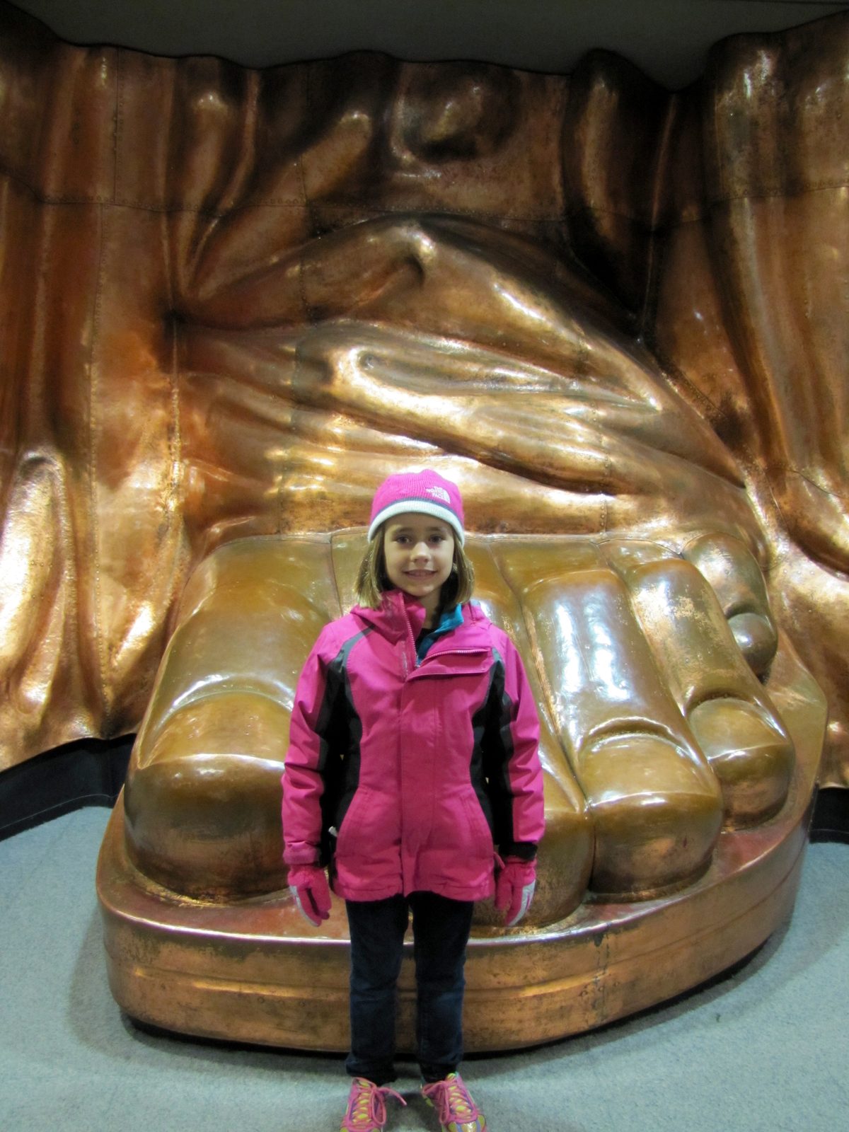 Lisa by the giant copper foot in the pedestal museum
