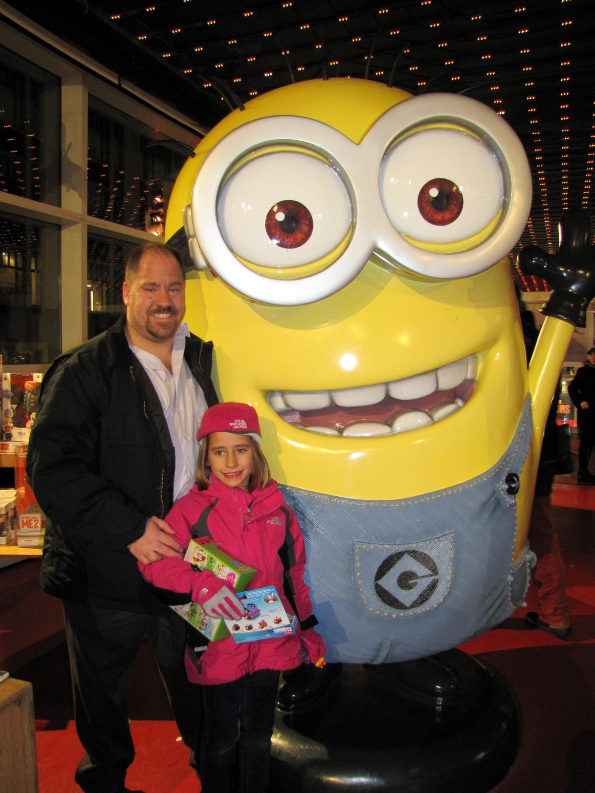 Lisa and Michael beside a giant Minion in the big city
