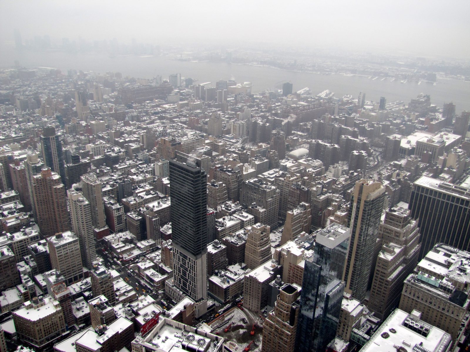 Looking straight down on the snow-dusted city blocks from way up high