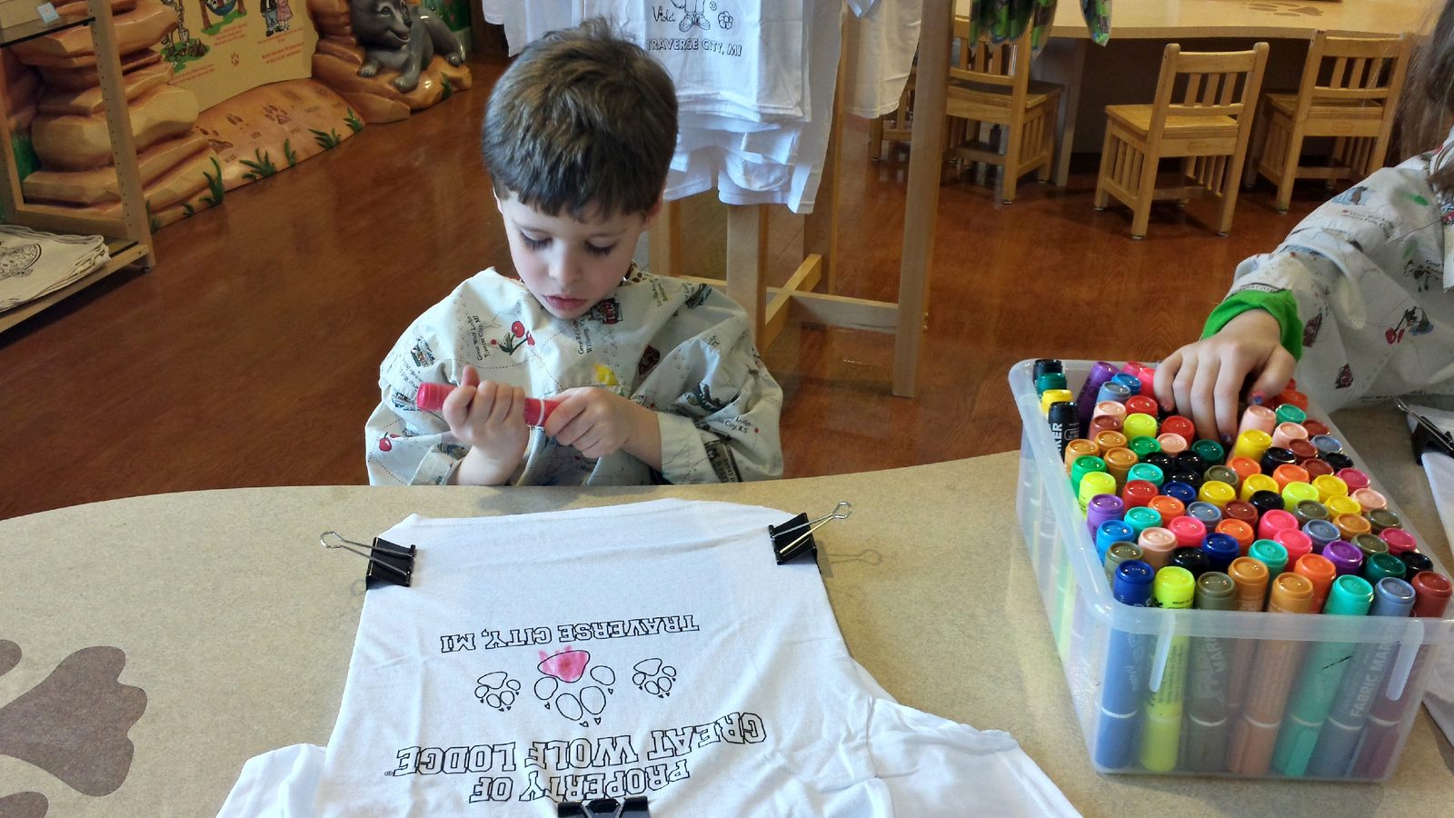 Thomas coloring his shirt at craft time