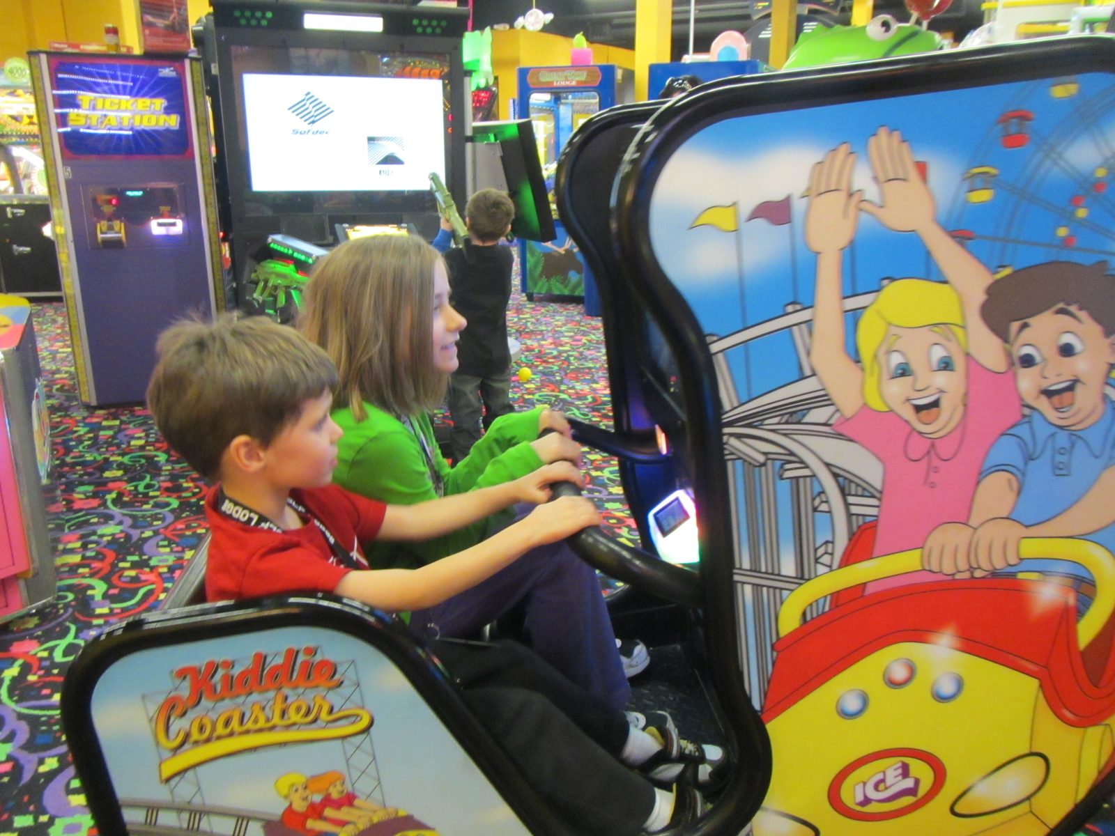 Lisa and Thomas ride the kiddie coaster