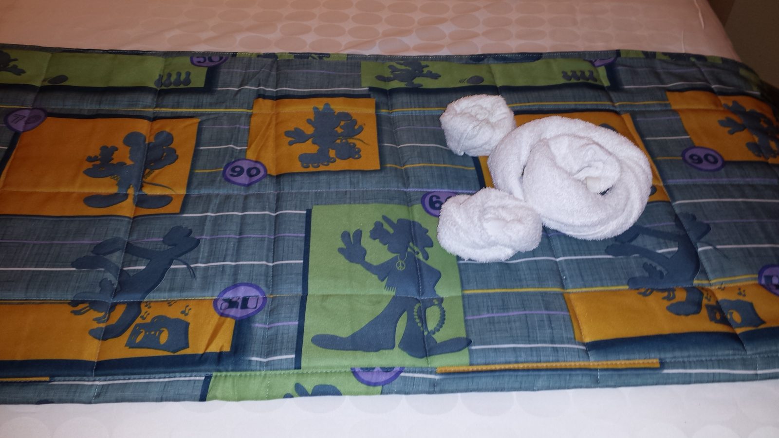 A towel creation waiting on our bed at Pop Century