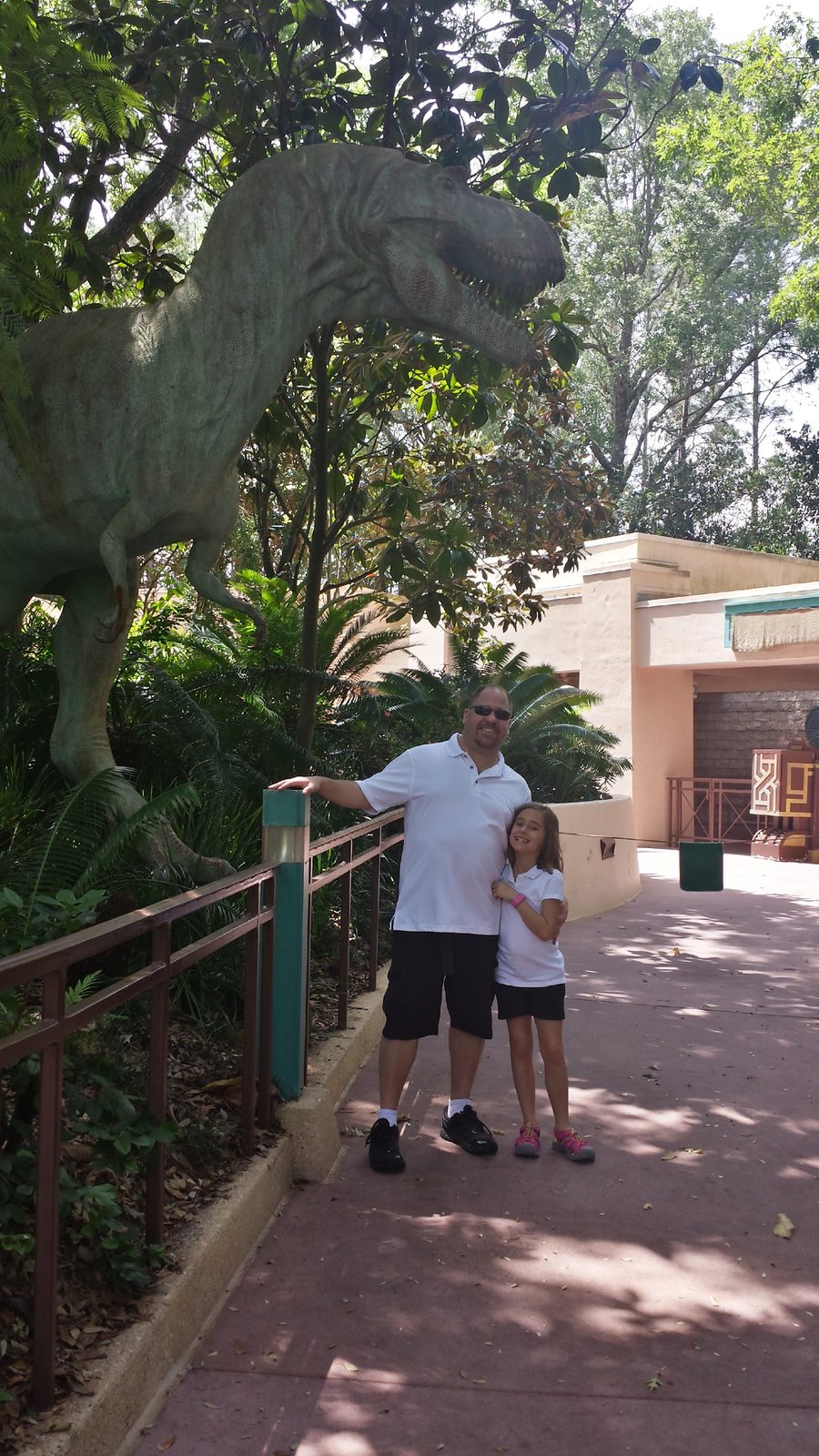 Lisa and Michael under a dinosaur in DinoLand