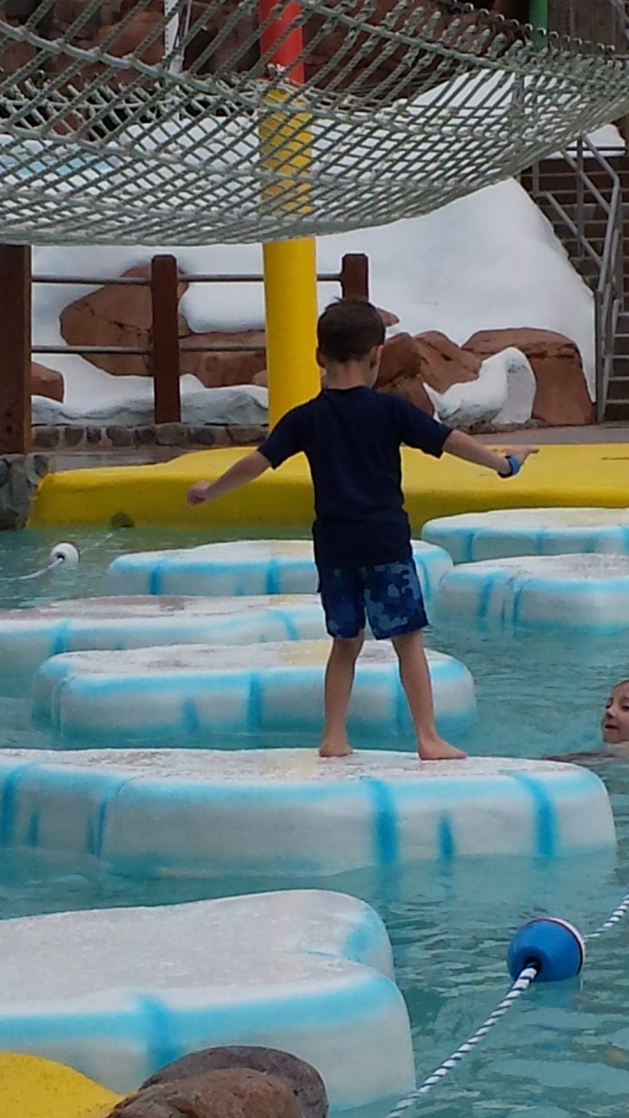 Thomas crossing the floating pads at the pool