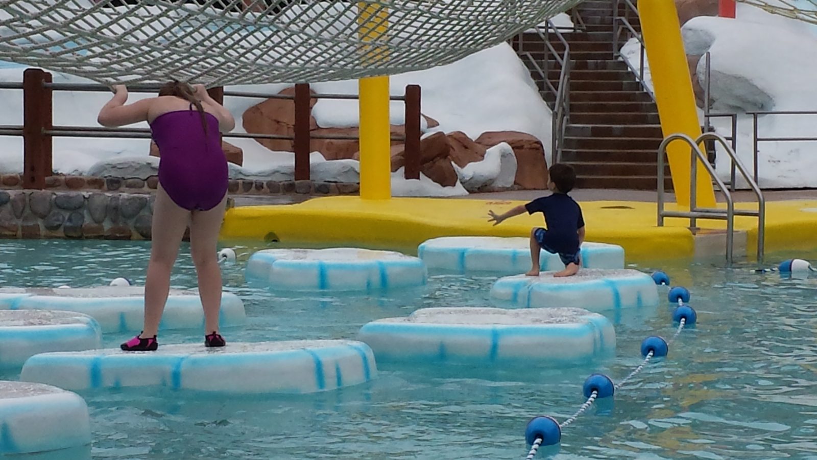 Splashing through the floating pads at the pool
