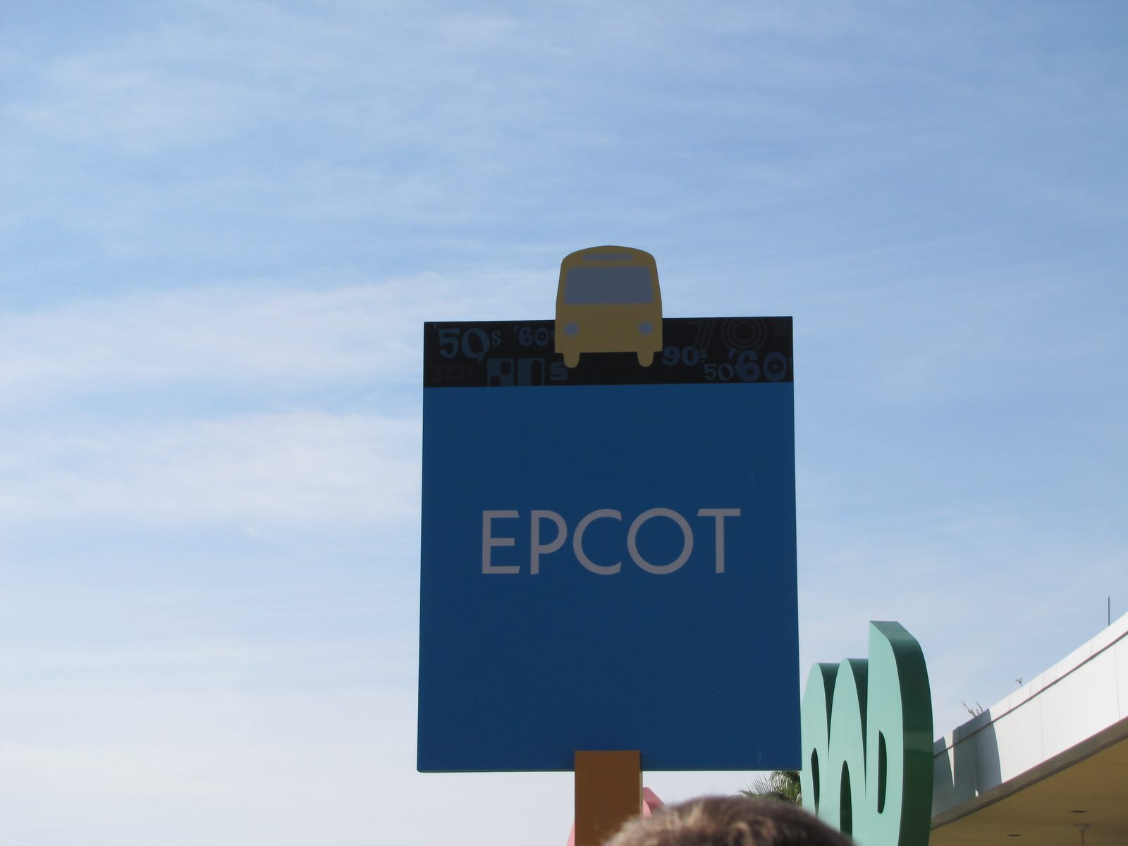 Walking in under the big blue Epcot sign