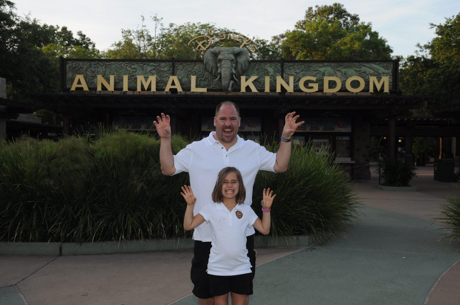 Waving goodbye under the Animal Kingdom sign